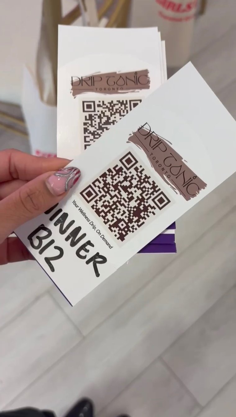 A guest holds her Drip Tonic card marked &ldquo;WINNER B12&rdquo; at Girls IRL.