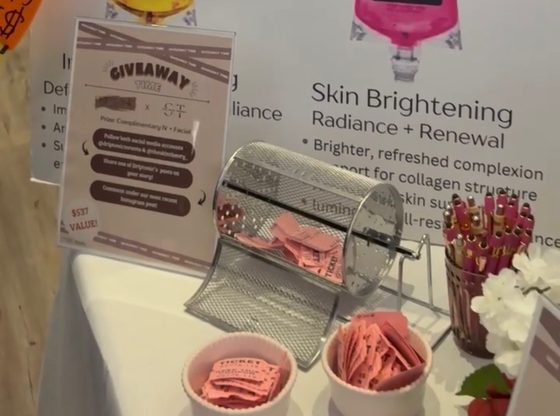 The raffle draw at the Drip Tonic wedding show booth, where one guest's name was picked for a complimentary IV and Skin Theory facial.